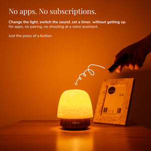 Havie controlled by remote, casting a warm orange glow on a bedside table.